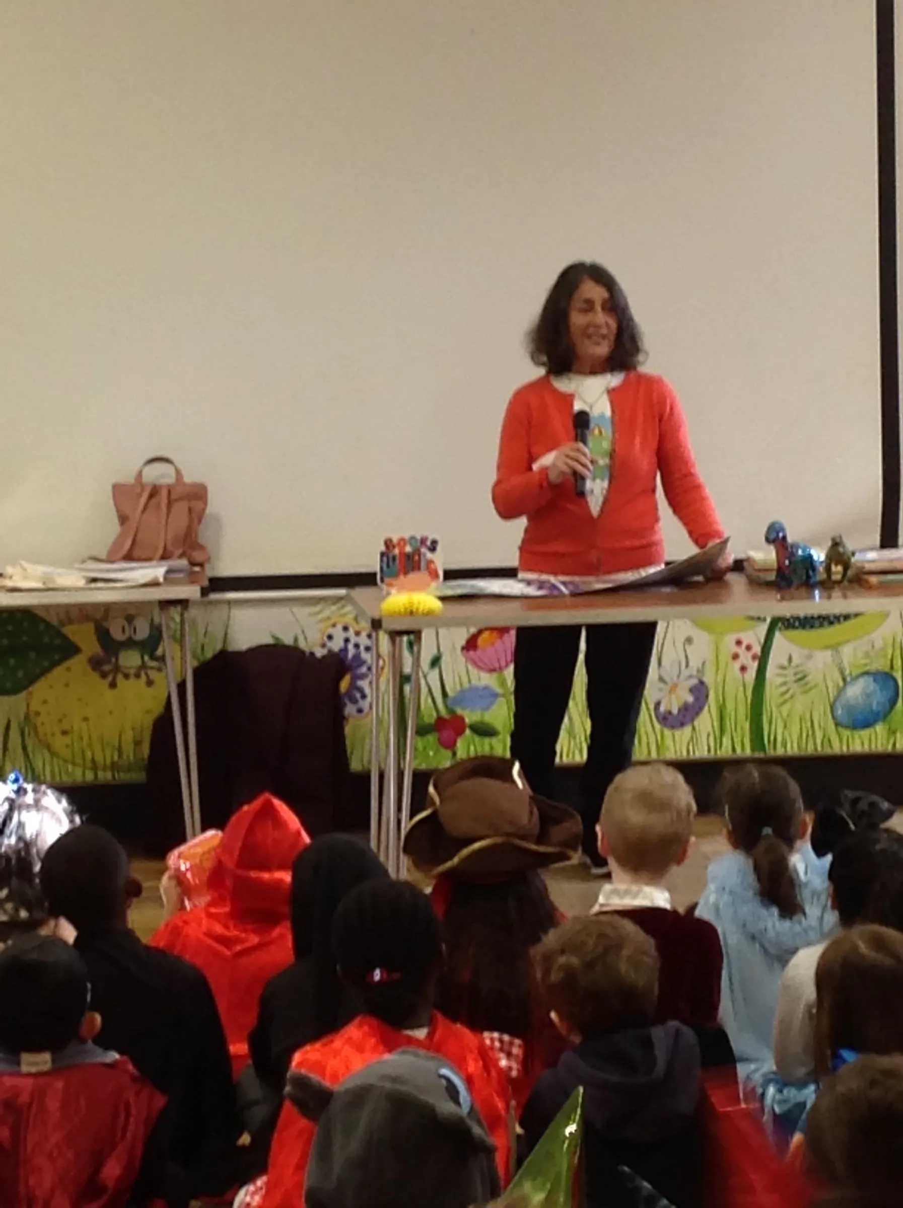 Heather Maisner speaking to a hall full of primary school children